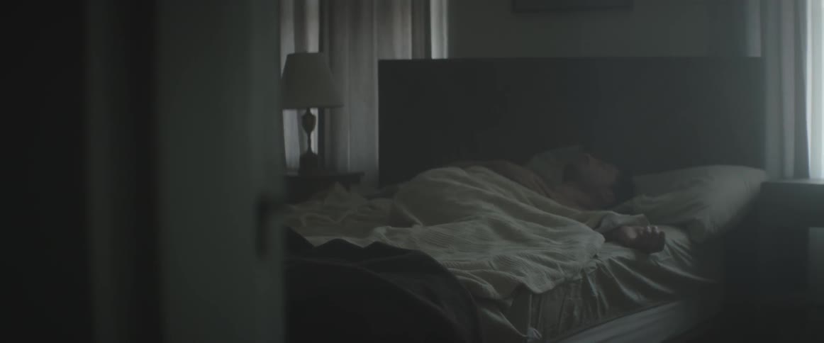 A man rolls over in bed