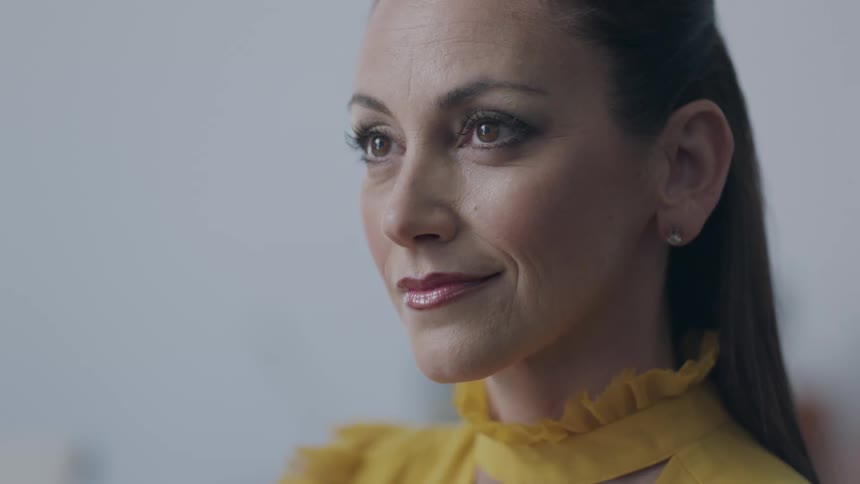 A woman nods her head and smiles