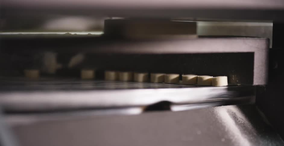 The pills fall from the machine
