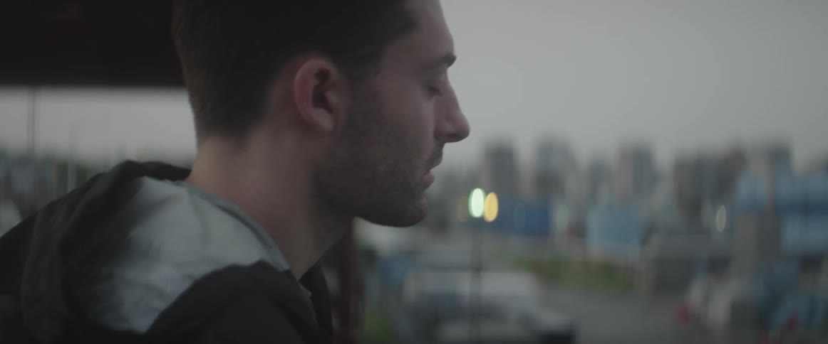 Man standing outside with his eyes closed