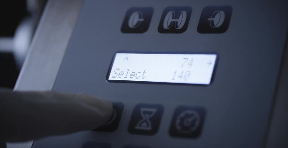 A person pushes a button on a machine