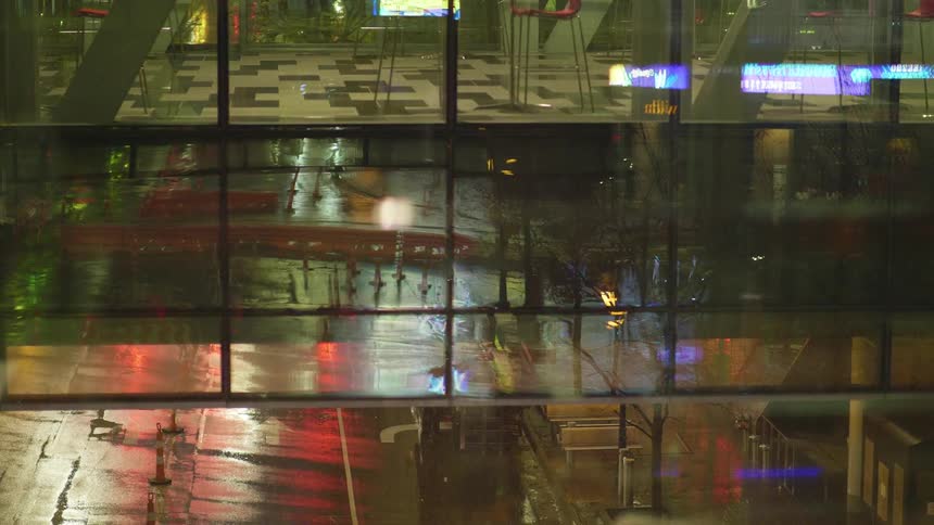 People walk down the street and inside the terminal with bags