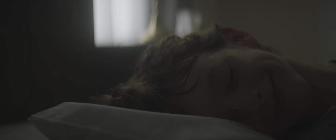 A child lying in bed, smiling