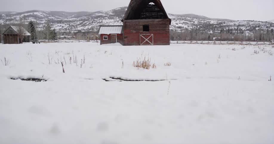 A barn on a snow covered field