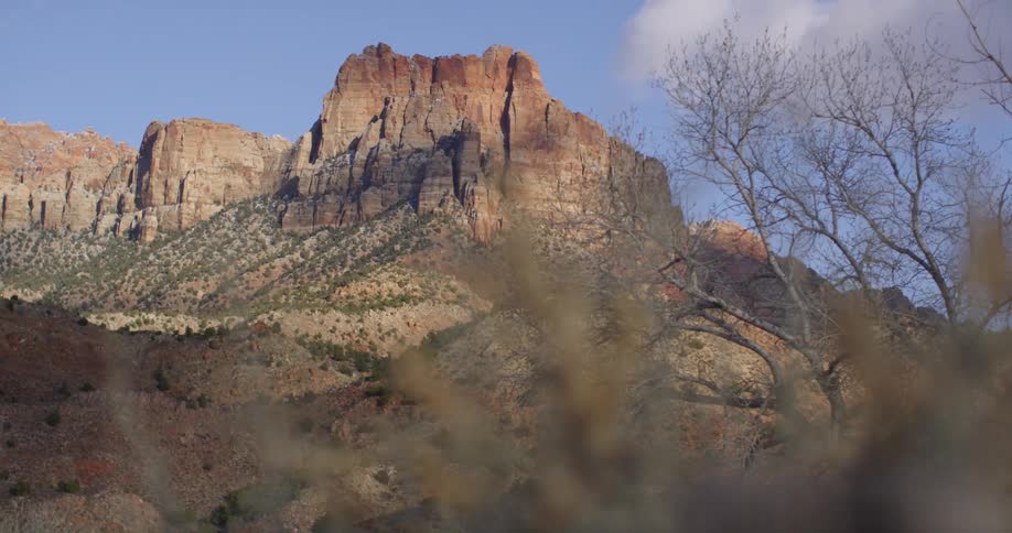 A large canyon with a blue sky behind it