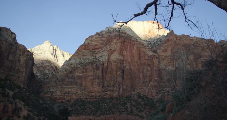 A canyon with a cliff with the sky in the background