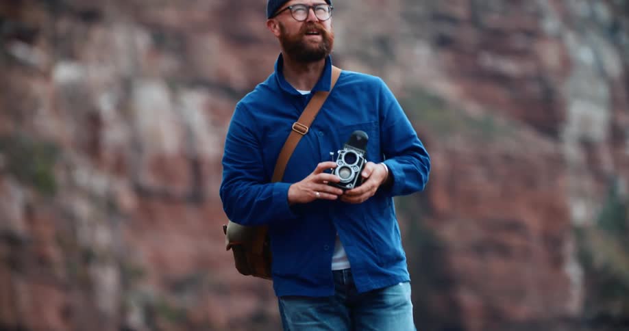 Male photographer looks for a good place to take pictures of the canyons