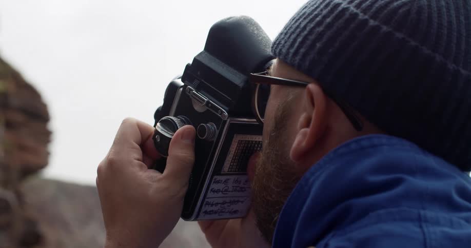 Male photographer takes a photograph of the canyons on a cloudy day