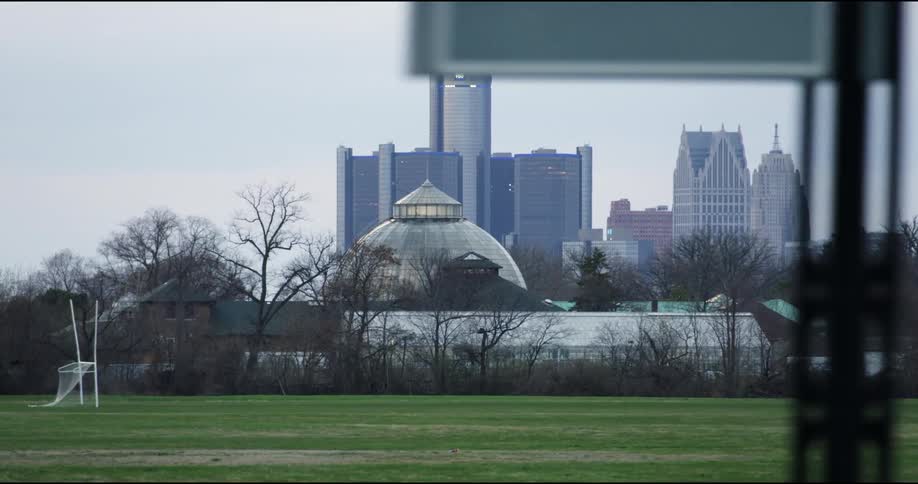 A sports field in front of a downtown area