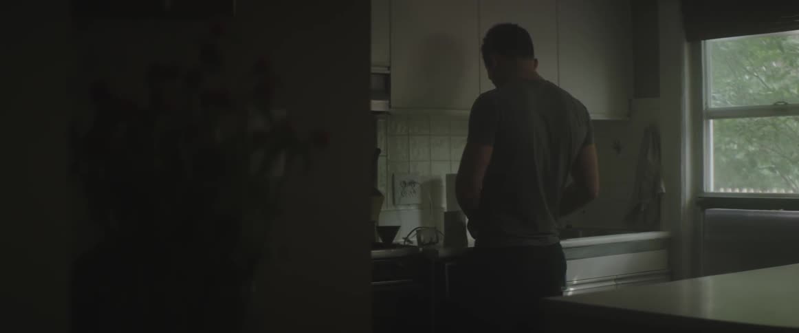 A man makes something in the kitchen