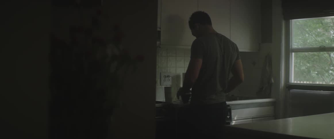 A man stands in his kitchen