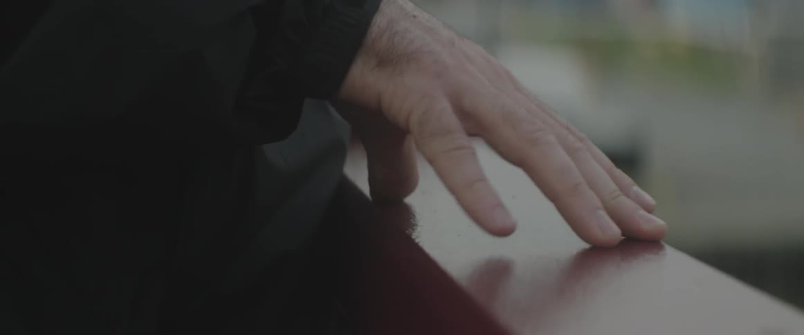 A hand rubs a ledge