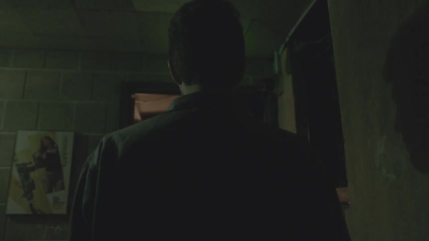 A man in a jacket walks toward a flickering light