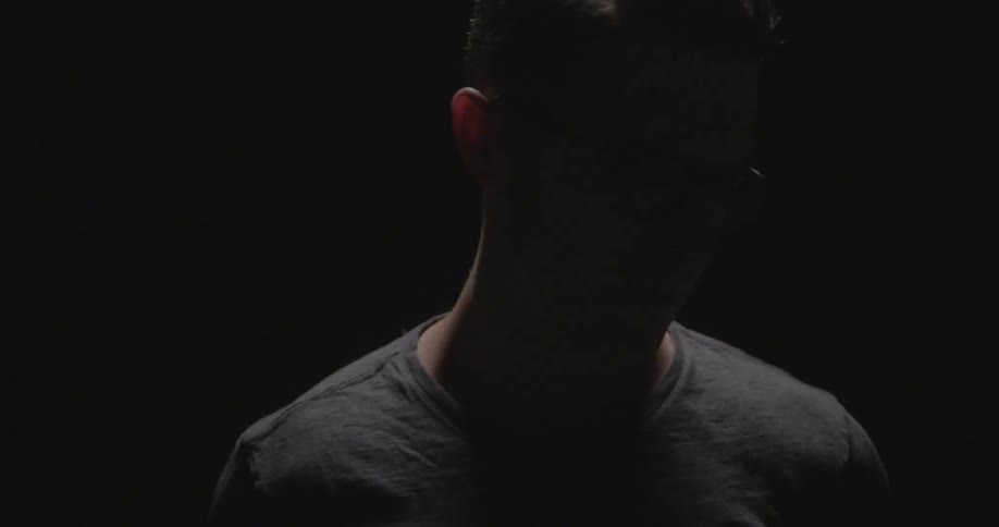A man standing alone in the dark