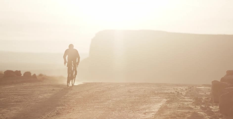 The person rides bike through the dirt