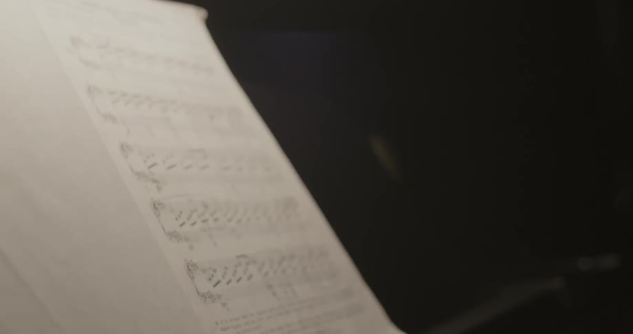Sheet music sits on a stand