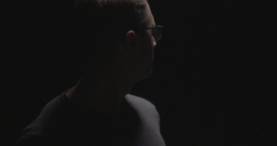 Man standing in dark room looking around