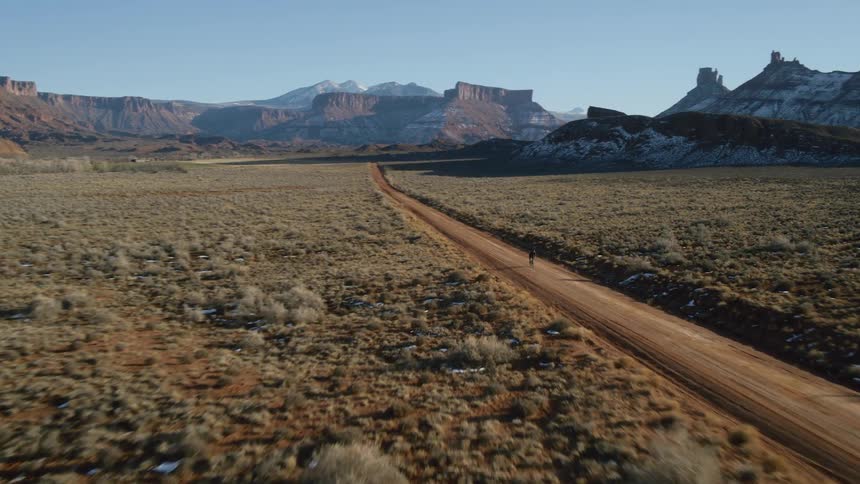 A person cycles through the desert