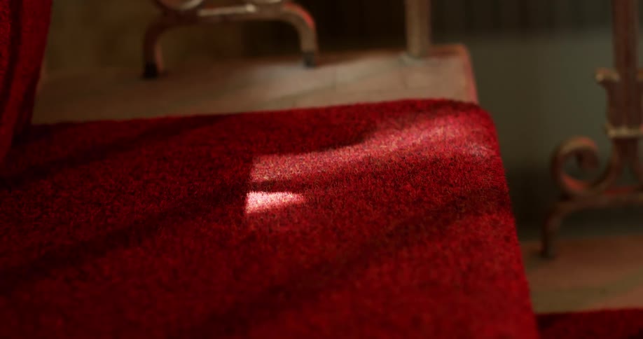 Waving curtain causes sunshine to occasionally shine on fabric