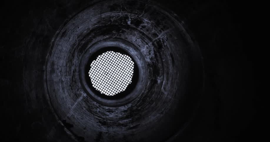 Worms eye view of a grate on an underground tunnel