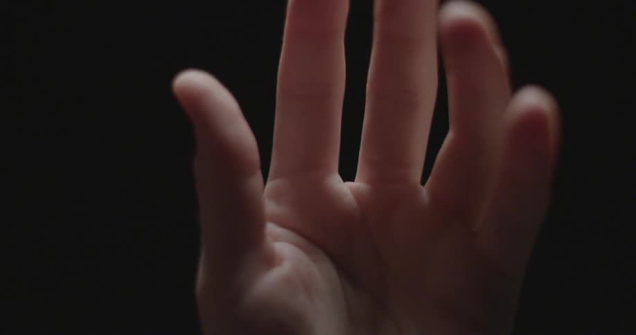 A hand is moving around in a dark area with one light