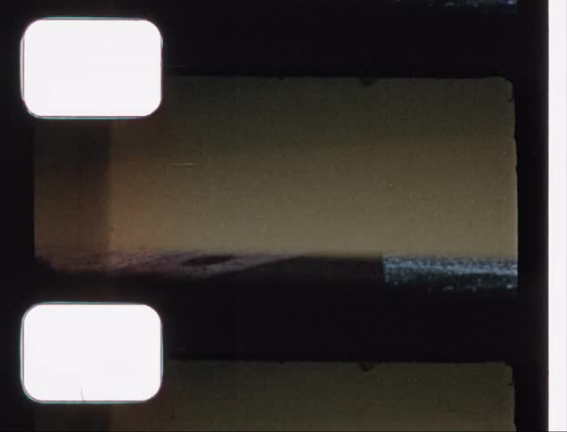 A glimpse of a block and pavement on an overexposed piece of old film