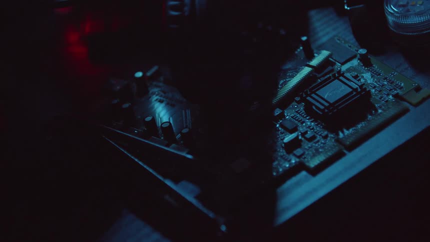 Two motherboards with exposed circuitry sit on a table