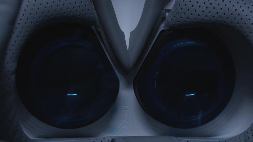Light reflects off two circular glass pieces inside of a rubber structure