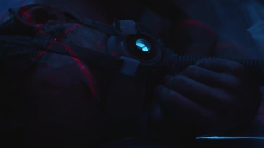 Hands hold a device as a red light moves over it