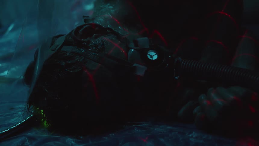 A teenager lying on plastic hooked up to a respirator