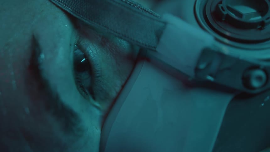 A person wearing a mask suddenly opens his eye