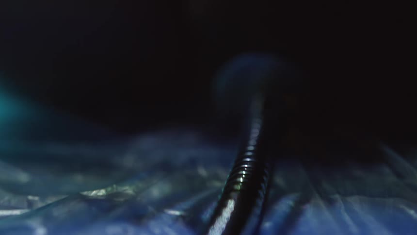 The light on the end of a metal cable blinking in various colors