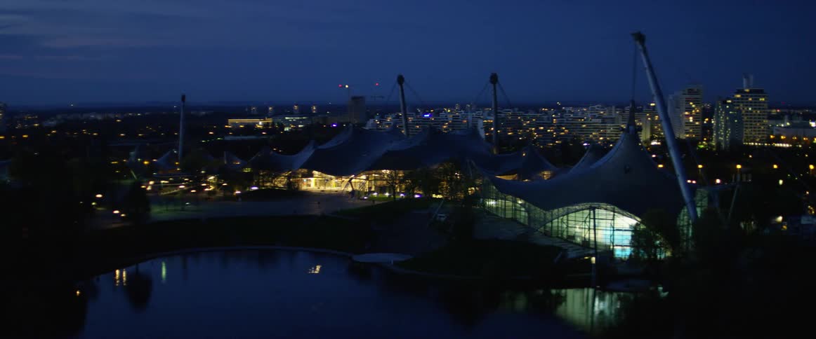 A pond with a city skyline in the background