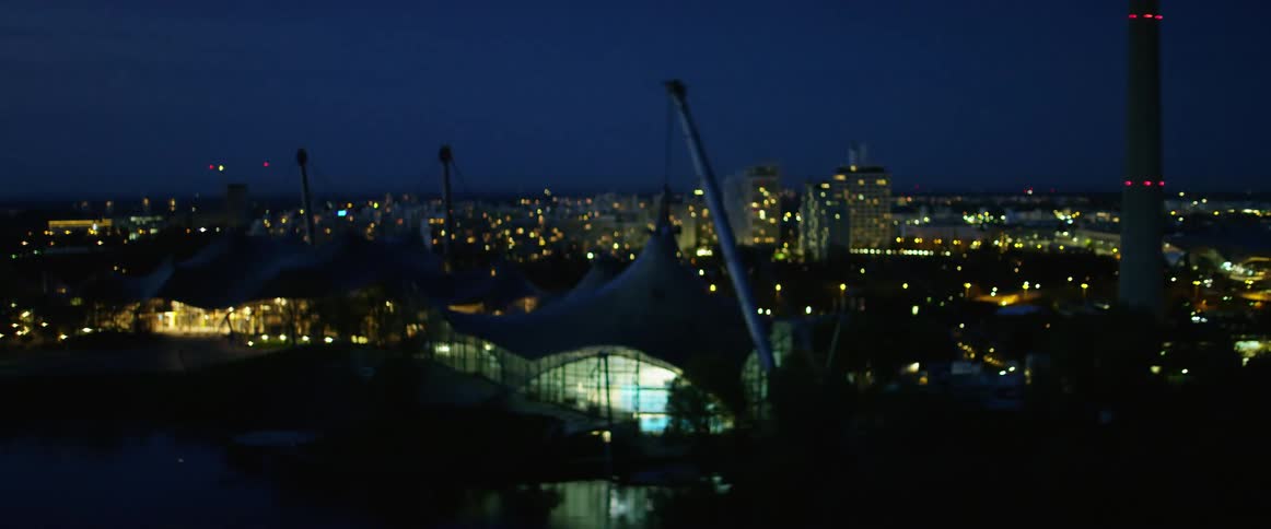Illuminated city sits under the night sky