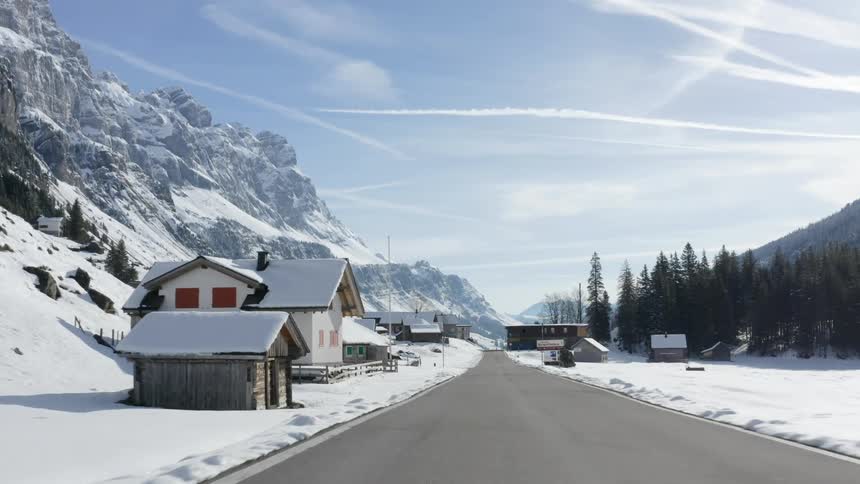 Buildings sit nestled in snowy mountains