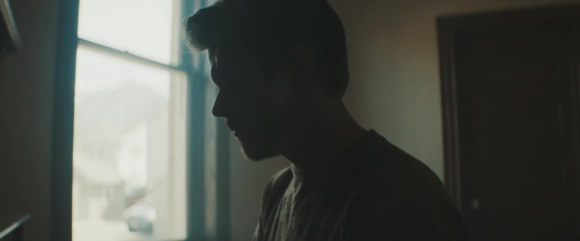 A silhouette of a pianist plays the piano