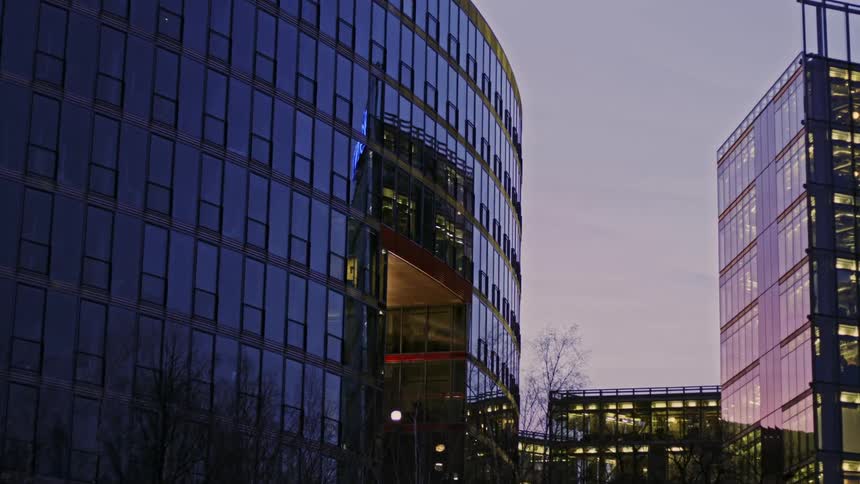 Buildings in a downtown city lit up at dusk