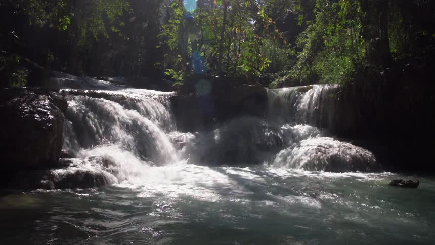 A water fall flows in to a river