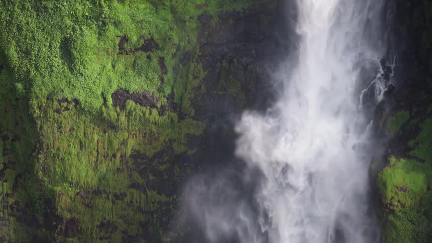 Powerful waterfall streaming down the face of a cliff