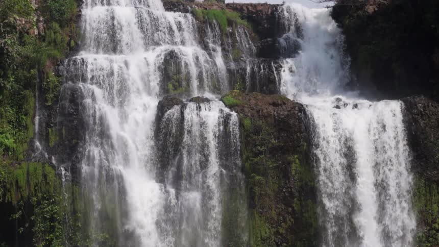 Waterfall cascades over moss covered rocks