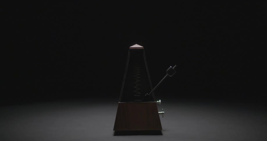 A metronome ticks back and forth