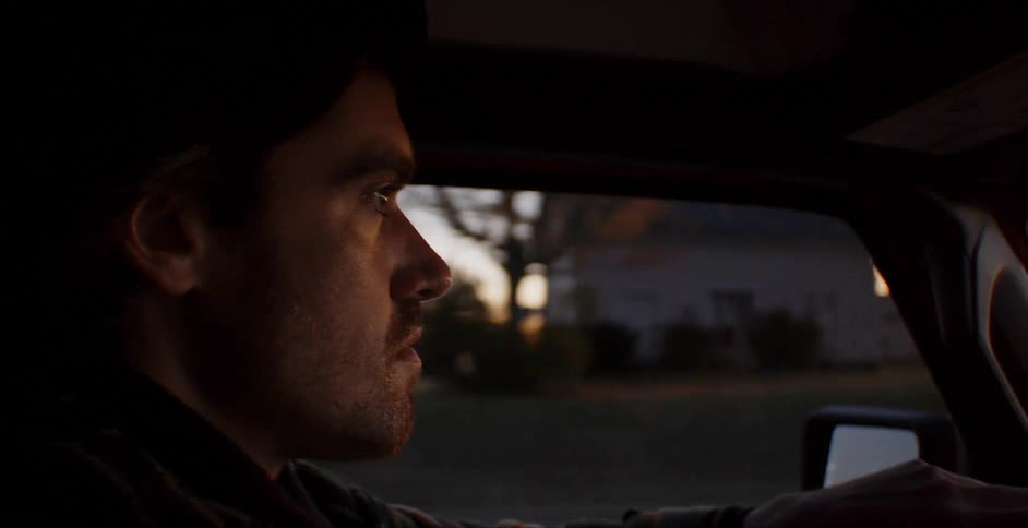 A man drives through a rural area