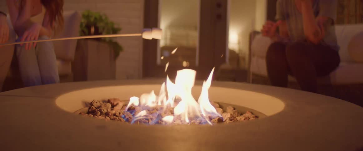 Two marshmallows are roasting over an open fire