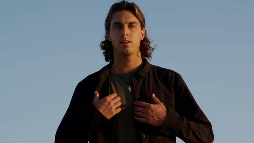 A man walking with the sky in the background