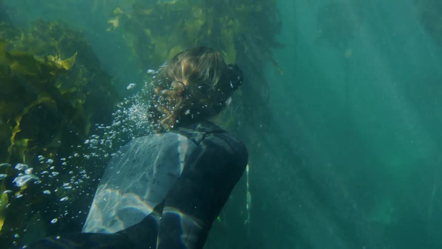 A woman swimming underwater