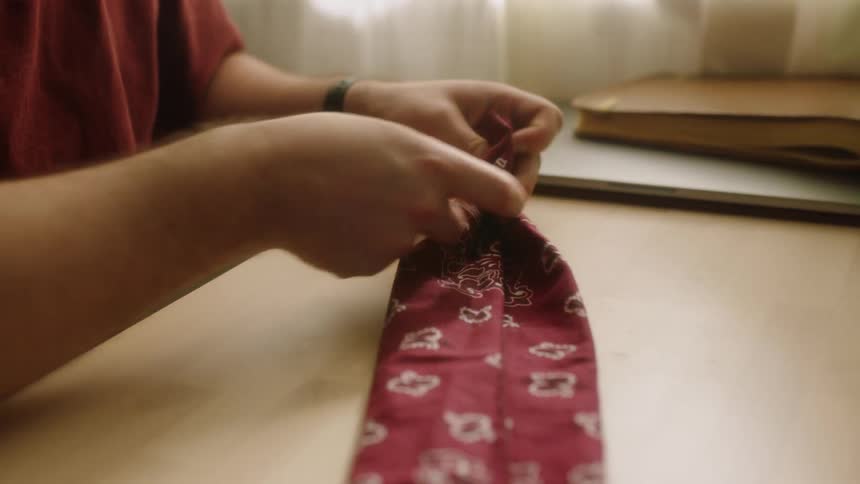 A white male rubs a piece of fabric with his fingers