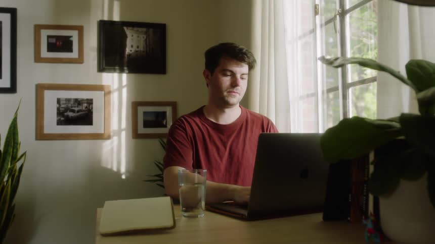 Man sitting at the table uses a laptop