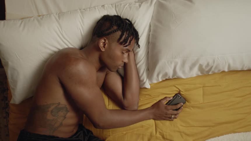 A man is sleeping on a bed indoors
