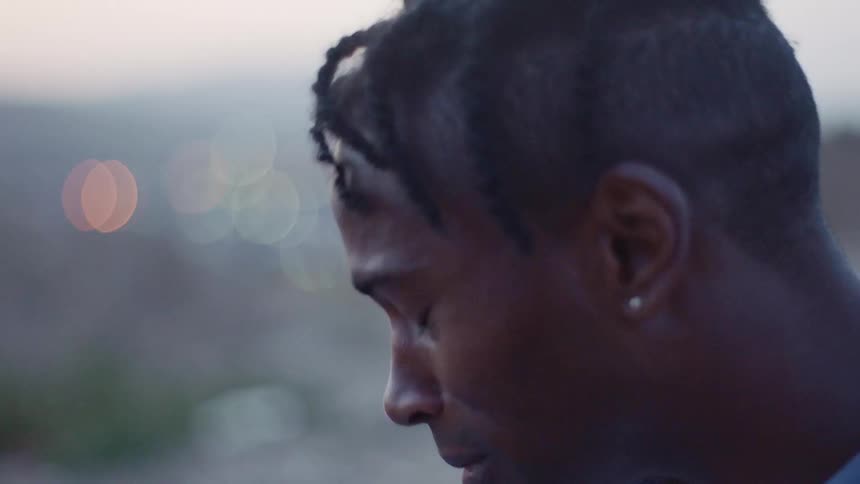 Upset black man drops his head down