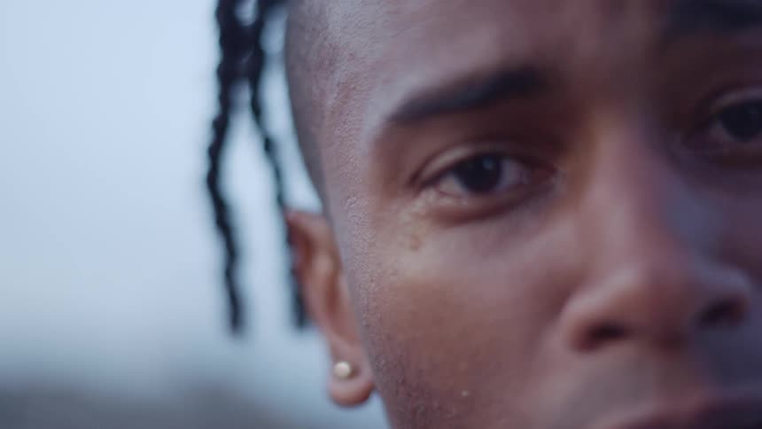 Close up of a mans face looking into the camera